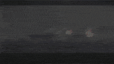 a large ship is on fire in the ocean with smoke coming out of it