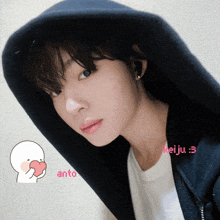 a girl wearing a black hoodie has a heart in her hand next to the word anto
