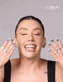 a woman is making a funny face with a l' oreal paris ad behind her