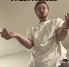 a man in a white t-shirt giving the middle finger