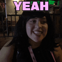 a woman is smiling with yeah written above her head