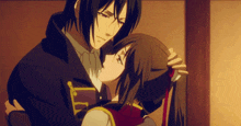a man and a woman are hugging each other with the man holding the woman 's hair