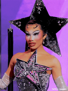 a woman is wearing a star shaped headpiece and gloves ..