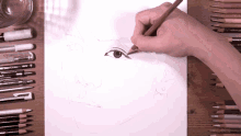 a person is drawing a woman 's face with a pencil that says faber castell