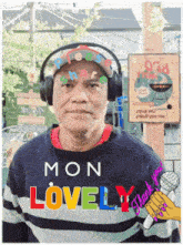 a man wearing headphones and a sweater with the words mon lovely written on it