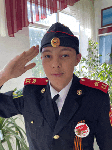 a young man in a military uniform salutes with a badge on his uniform that says " mar "