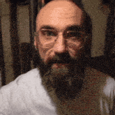 a bald man with a beard wearing glasses