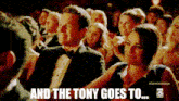 a man in a tuxedo sits in a crowd with the words and the tony goes to written above him