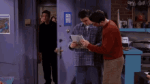 a man in a plaid shirt is holding a piece of paper and says slut