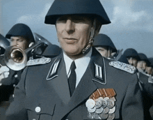 a man in a military uniform with medals on his collar