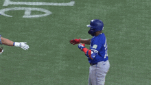 two blue jays baseball players high fiving each other