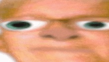 a close up of a person 's face with glasses and big green eyes