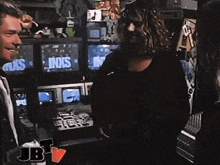 two men are standing in front of a screen that says inxs on it