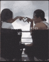 a couple making a heart shape with their hands with the words another month with you