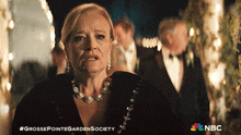 a grosse pointe garden society advertisement with a woman in a black dress and pearl necklace