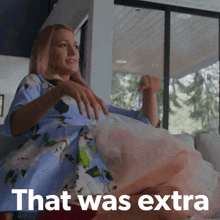 a woman is sitting on a couch with the words that was extra written on the bottom