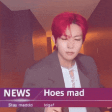 a man with red hair is standing in front of a news banner that says news hoes mad