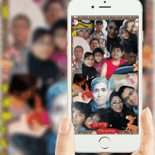 a cell phone with a merry christmas message on the screen