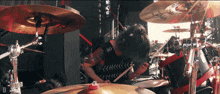 a person playing a drum set with a zildjian cymbal in the background