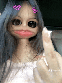 a doll with big eyes and pink lips is giving a middle finger
