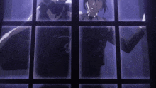 a man in a suit looks out of a window