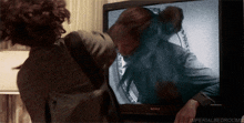 a person looking at a sony television with the caption imperial bedrooms