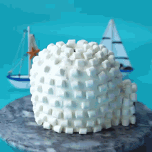 a cake that looks like an igloo made out of marshmallows on a table