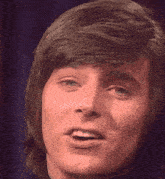a close up of a man 's face with a smile on his face