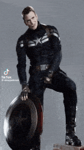 a man in a captain america uniform holds a shield