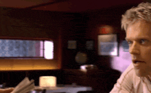 a man sitting at a table looking at something