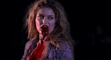 a woman with blood on her face and neck