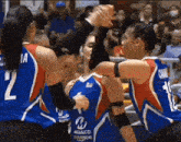 a group of female basketball players are giving each other a high five while wearing jerseys that say metalco