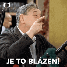 a man covering his nose with his finger and the words je to blazen written below him