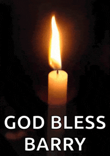 a candle is lit up in the dark and the words `` god bless barry '' are written below it .