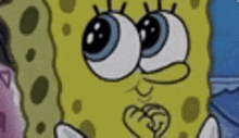 a close up of a cartoon character , spongebob squarepants , with big blue eyes .