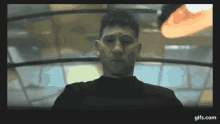 a man 's face is shown in a blurry photo with the website gifs.com at the bottom of the screen