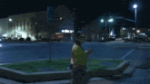 a man wearing glasses and a t-shirt with a picture of a woman on it walks down a street