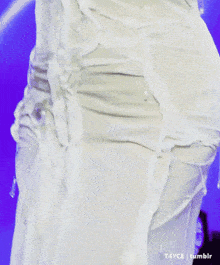 a close up of a woman 's breasts in a white shirt .