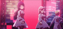 three anime girls are holding hands and dancing on a stage in front of a city skyline .