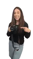 a woman is holding a canon camera and pointing