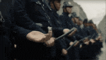a blurred image of a group of soldiers holding their hands together