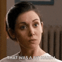 a woman is making a funny face and says `` that was a bit harsh '' .