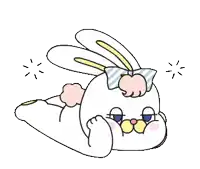 a bunny with a bow on its head is laying down