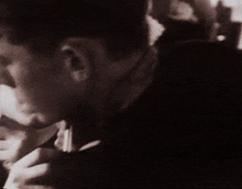 two men are looking at each other and one has his hand on the other 's face