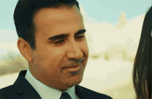 a man in a suit and tie is talking to a woman .