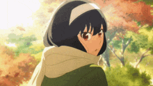 a girl with short black hair and red eyes is wearing a scarf around her neck and head .