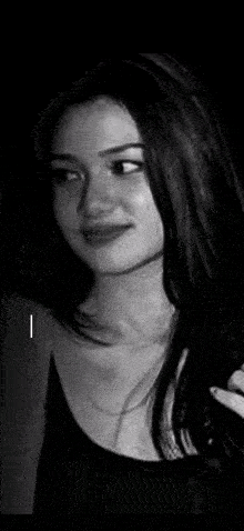 a black and white photo of a person 's face with a light coming out of their mouth .
