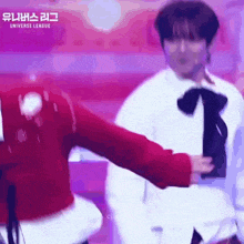 a man and a woman are dancing on a stage in front of a sign that says universe league .