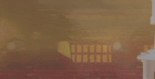 a blurred image of a room with a red fence and a clock on the wall
