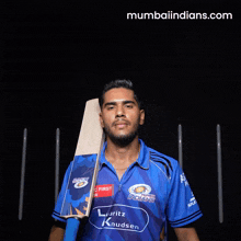 a man in a blue shirt that says mumbai indians on it